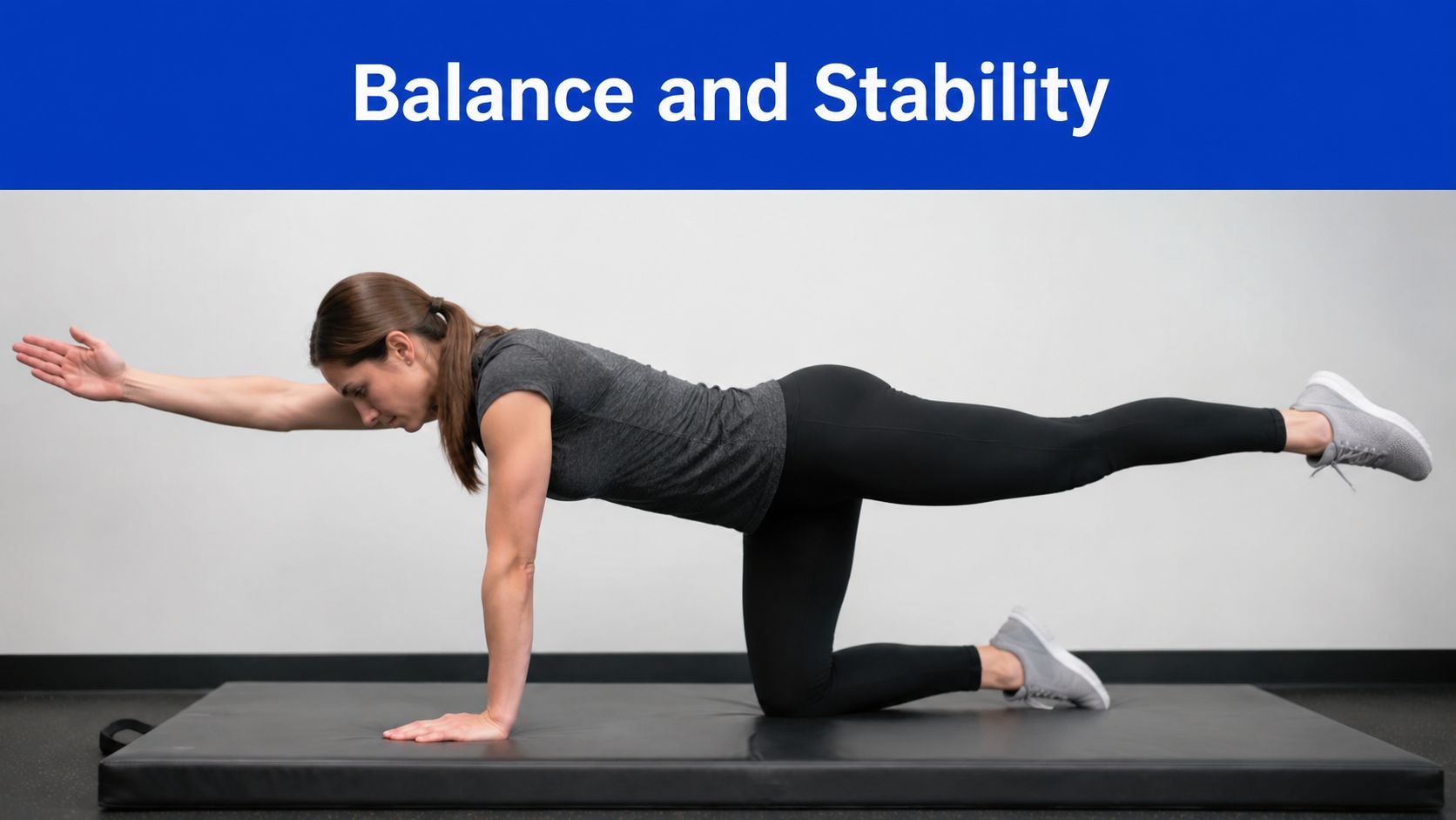 A woman performing a bird-dog exercise on a black mat for balance and stability.