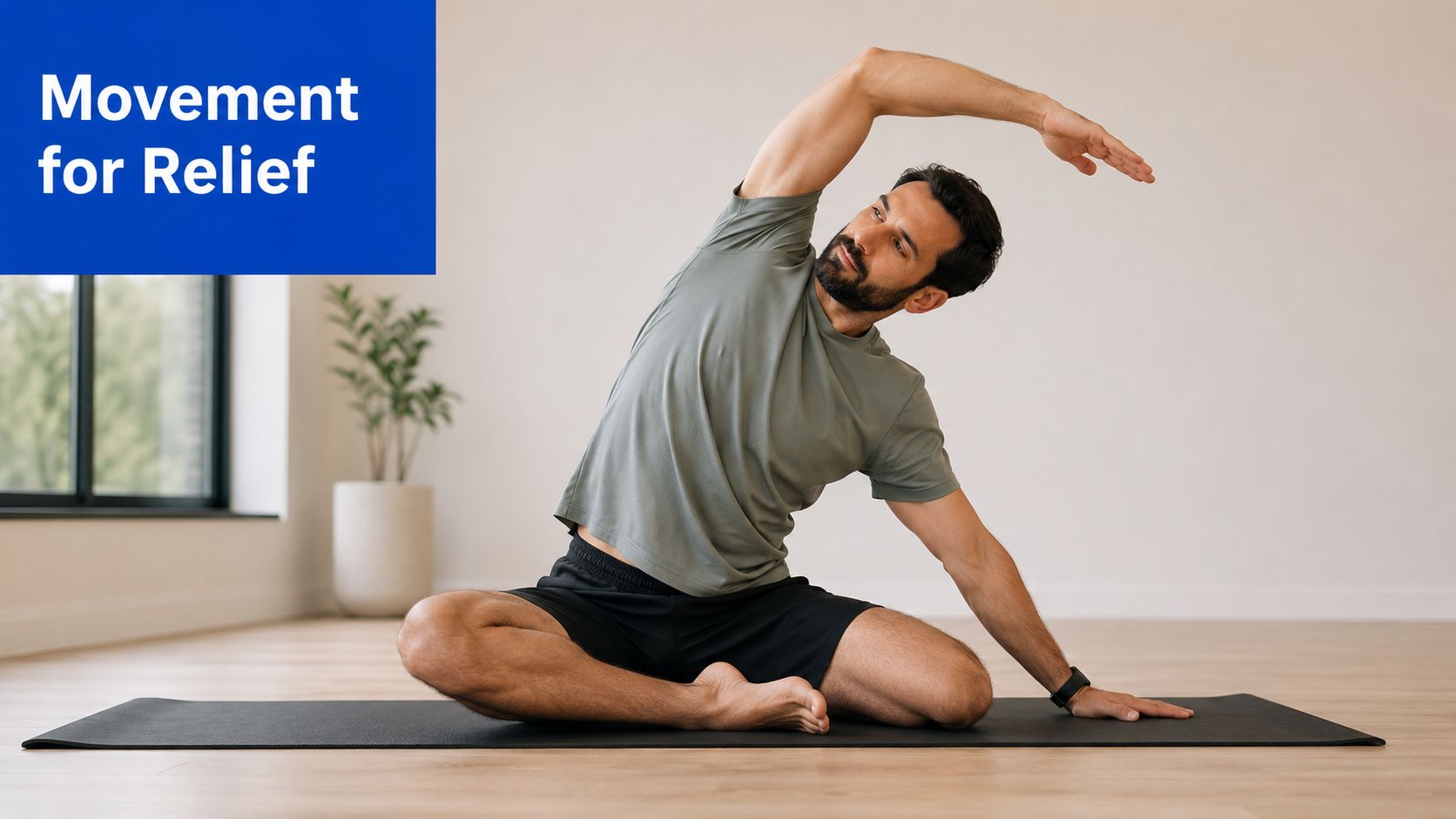 A bearded man performing a seated side-stretching exercise on a yoga mat in a minimalist studio.