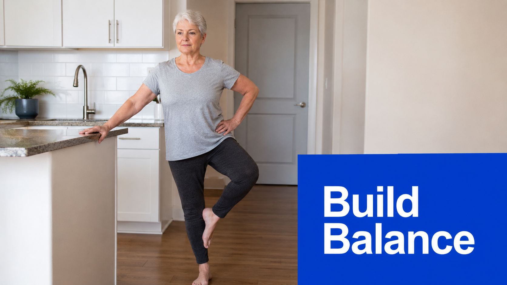 An older woman in a kitchen practicing a balance exercise by standing on one leg.