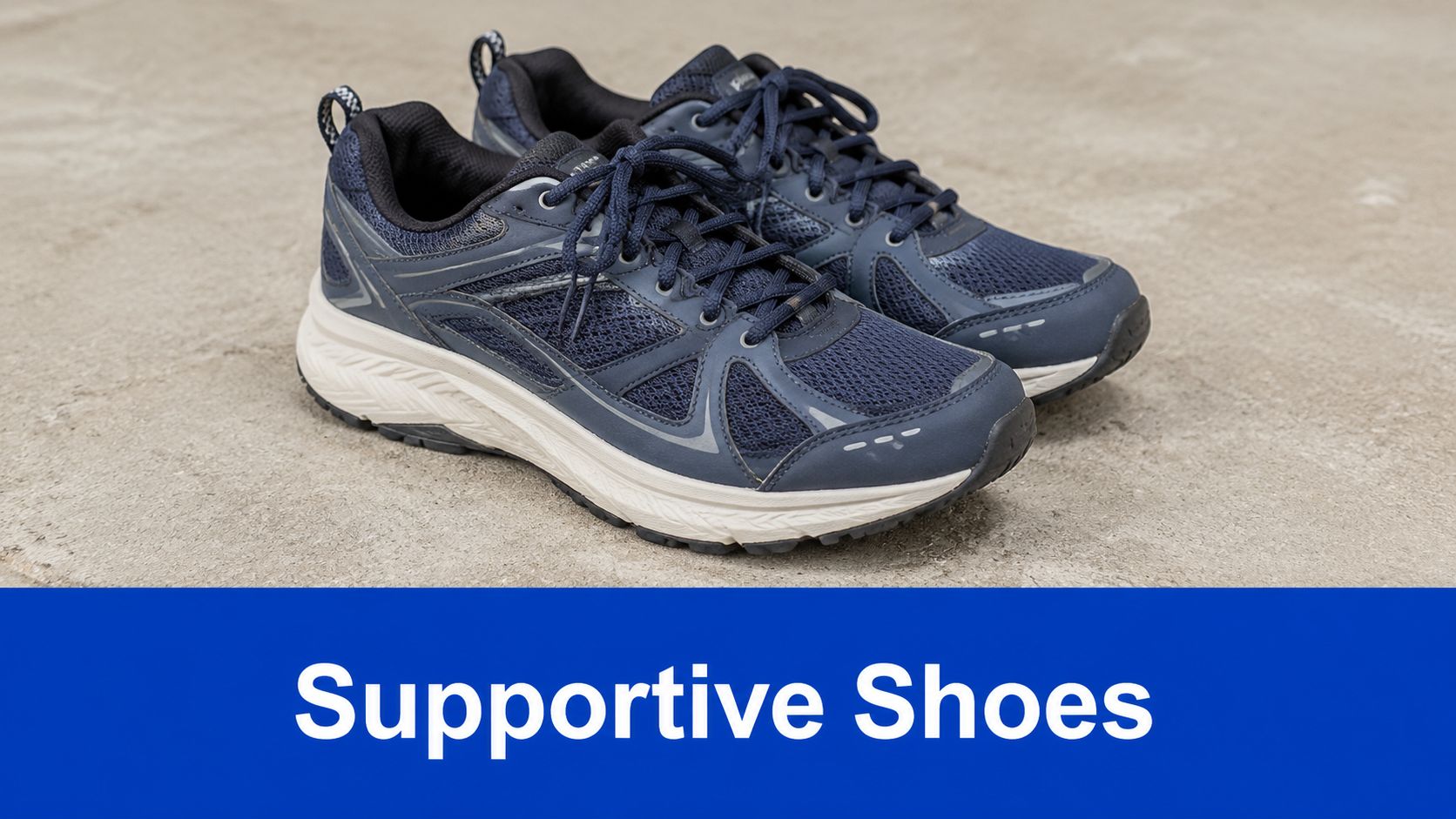 A pair of navy blue supportive athletic sneakers placed on a grey concrete background.
