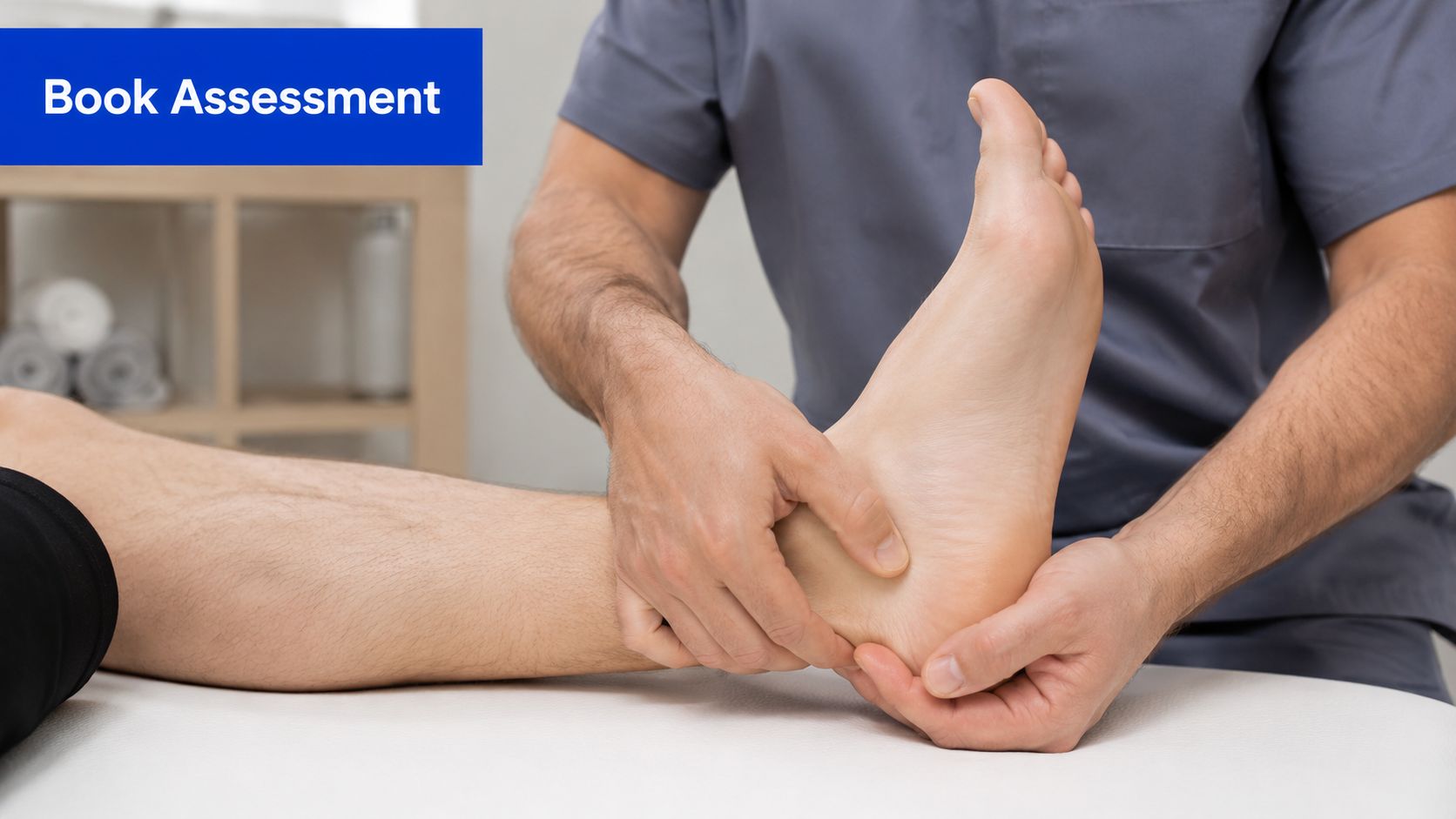 A professional physical therapist examines and massages a patient's foot to treat pain during a clinical consultation.
