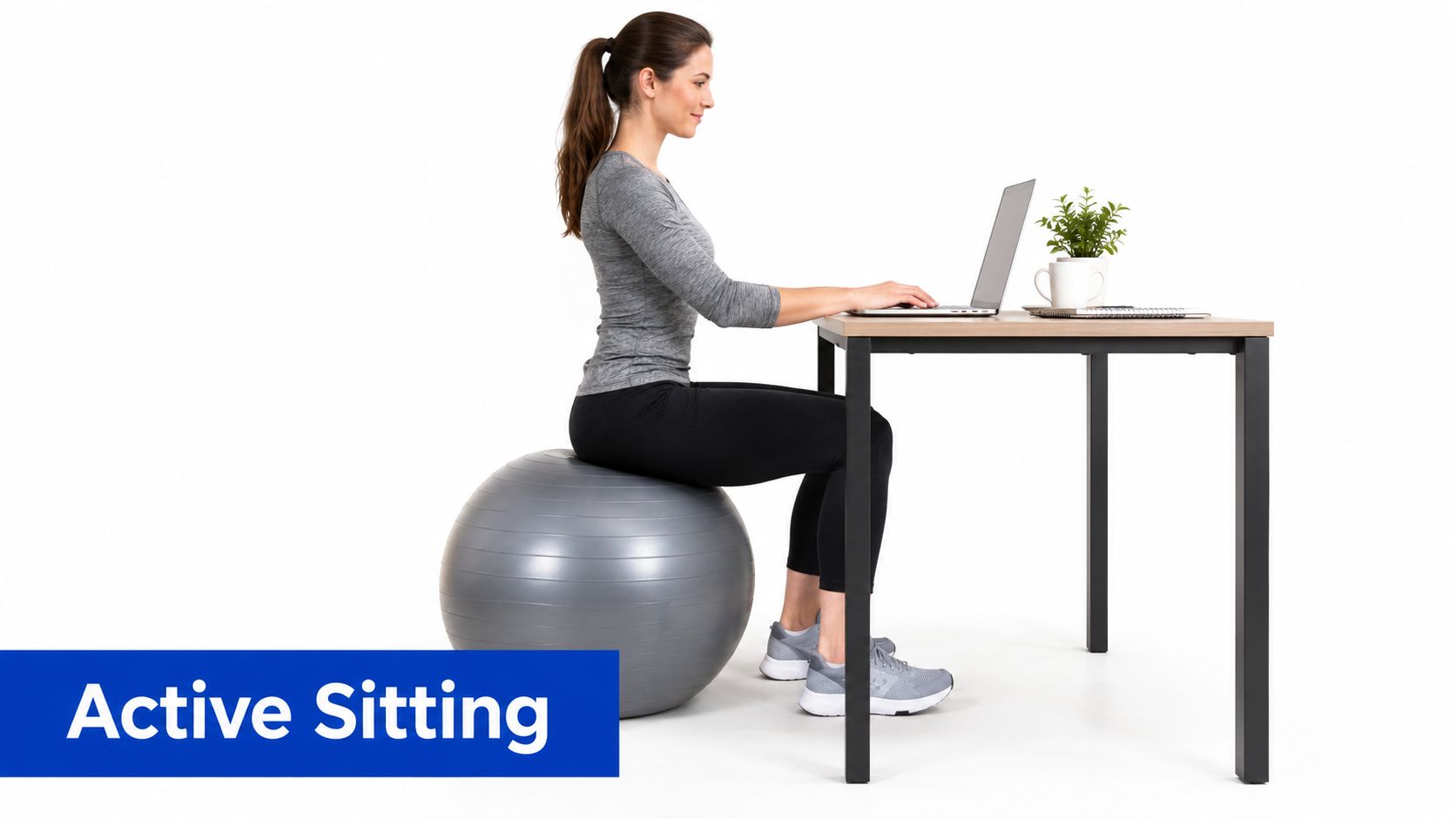 A woman using an exercise ball as an office chair while working on a laptop at her desk.